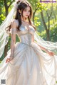 a woman in a wedding dress standing in the woods